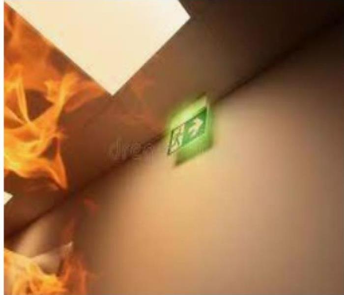 white walls with green emergency exit sign with orange and yellow flames